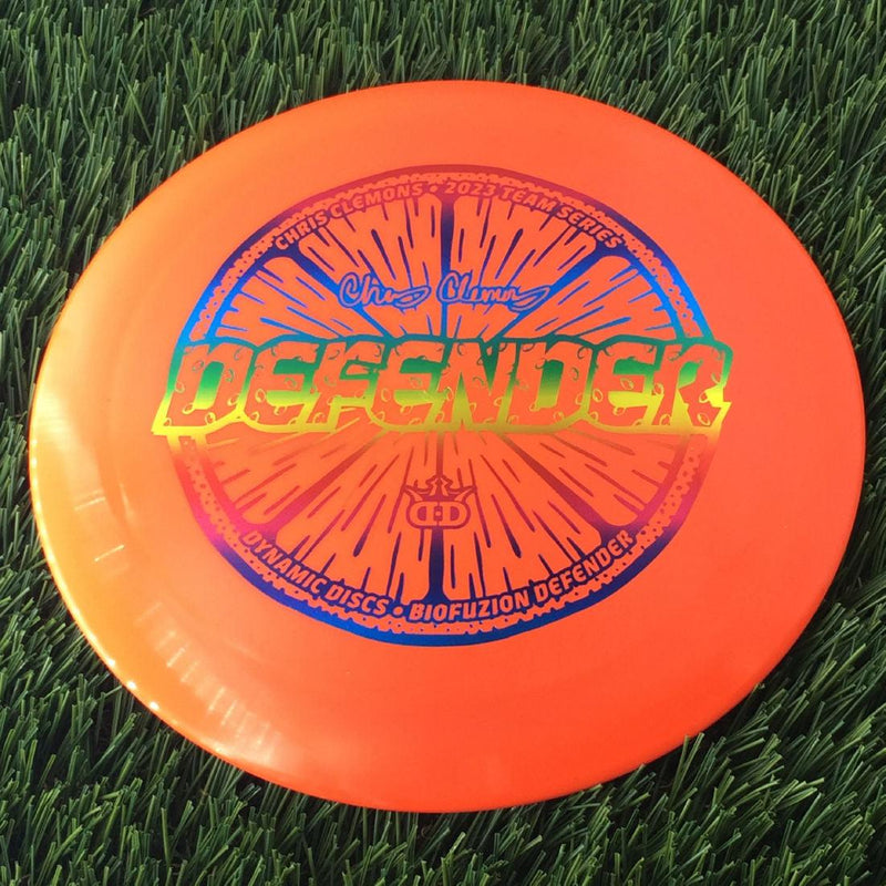 Dynamic Discs BioFuzion Defender with Chris Clemons Lemon Seeds Team Series 2023 Stamp - 173g Orange