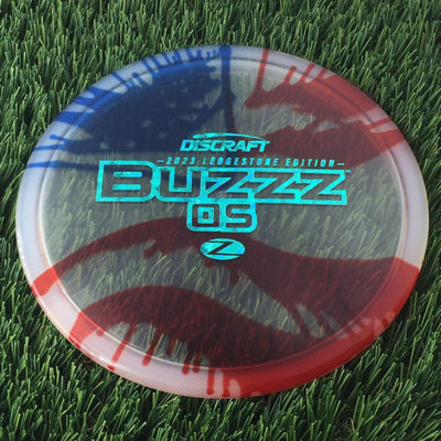 Discraft Elite Z Fly-Dyed BuzzzOS with 2023 Ledgestone Edition - Wave 2 Stamp - 180g - Translucent Flag