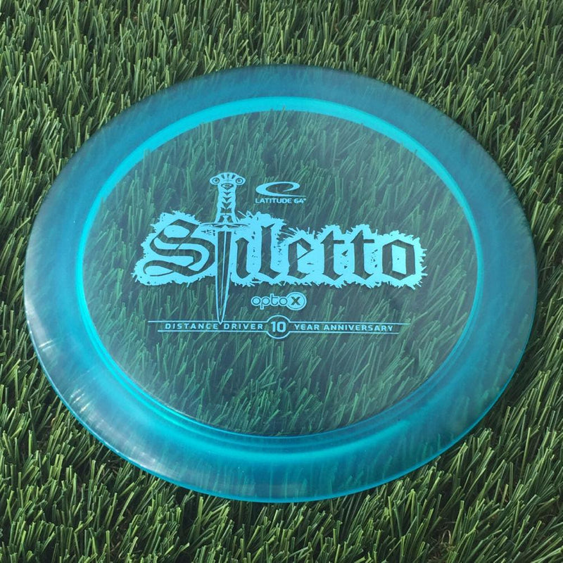 Latitude 64 Opto-X Stiletto with 10 Year Anniversary Sword Stamp - 173g - Translucent Blue